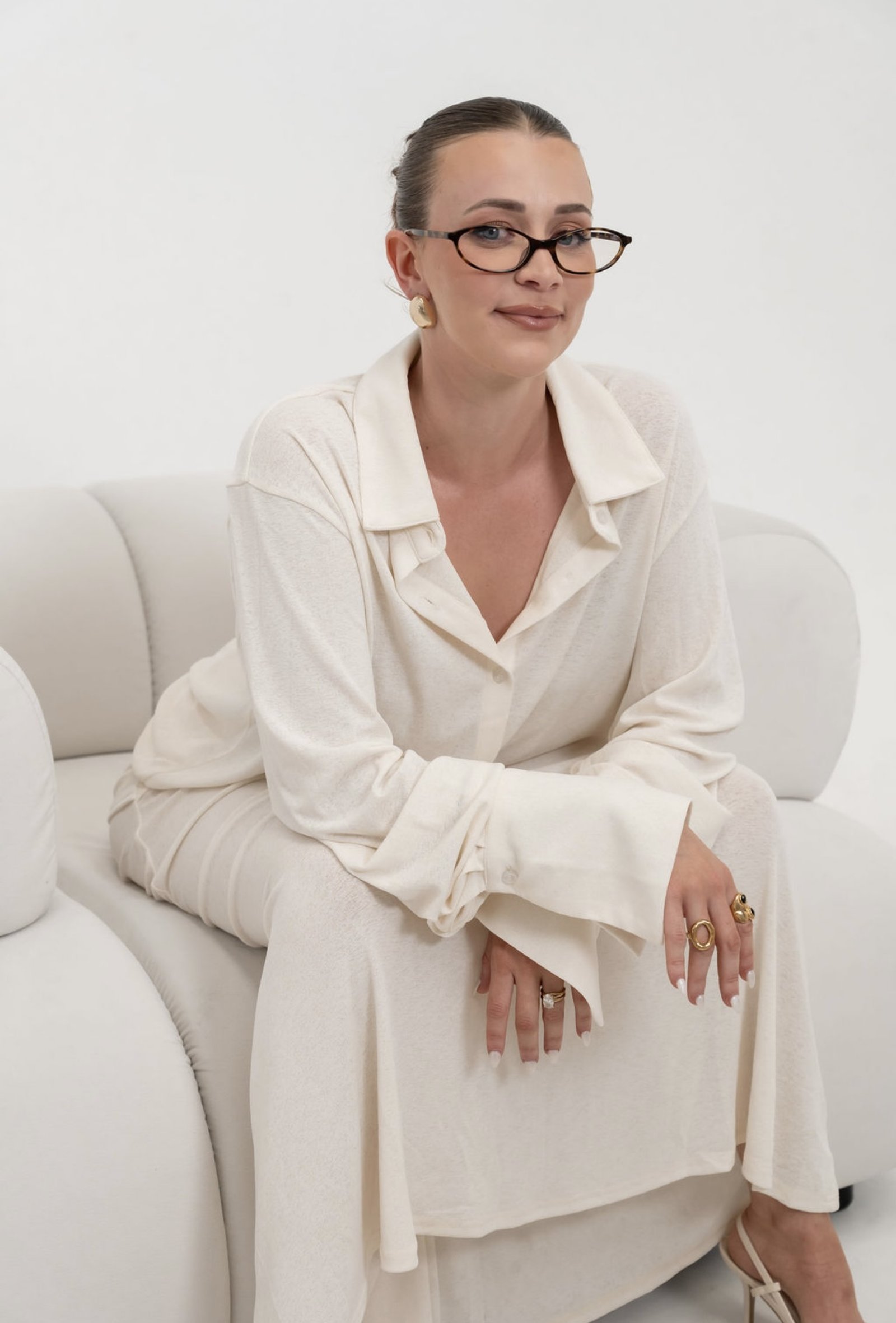 Chloe, founder of The Skin Method, seated in a calm white outfit